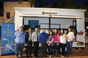 Students posing with mobile market trailer