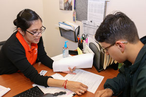 TSC Academic Advisor Alejandra Parra assists a student with course registration at the college’s one-stop-shop at the Oliveira Student Services Center.