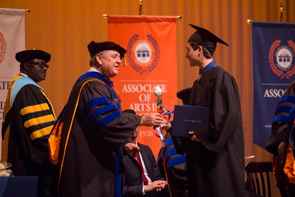 Texas Southmost College Board of Trustees Secretary Ruben Herrera congratulates a graduate during the fall 2016 commencement ceremony on Dec. 17, 2016 at TSC’s Jacob Brown Memorial Auditorium.